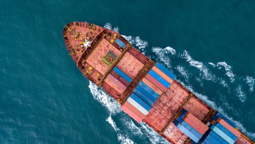 Aerial view of a container ship sailing through open water