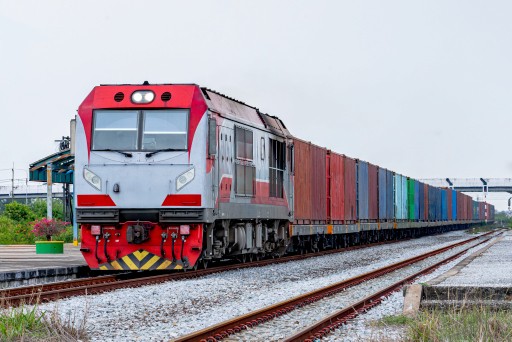 Freight train pulling cargo containers along a rail line