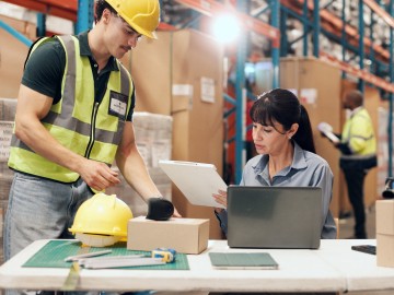 Warehouse team inspecting cargo at a work station
